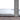Roll of gray carpet with a ruler for scale on a wooden floor.