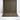 Brown textured rug with geometric pattern on a white floor.