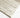 Close-up of textured wool pile and linear arch motif in ivory/beige