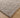 Close-up of a textured gray rug on a wooden floor