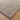 Close-up of a textured gray rug on a wooden floor