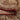 Close-up of a patterned rug with red and beige colors