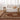 Living room with a patterned rug, white sofa, and wooden side tables.