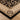 Decorative rug with intricate patterns on a wooden floor