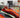 Abstract swirl rug in red, black, and orange styled in modern living room