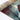 Tiffany Autumn Leaf Modern Rug rolled view in multi-colour red, blue, and green design