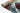 Tiffany Autumn Leaf Modern Rug rolled view in multi-colour red, blue, and green design
