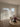 Living room with sheer curtains, a couch, and a coffee table with decor items.