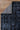 Close-up of a dark blue patterned rug on a wooden floor