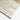 Close-up of textured wool pile and linear arch motif in ivory/beige