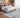 Bluehaven Light Grey distressed rug styled in a modern bedroom