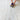 Person using a small vacuum cleaner on a textured white carpet