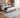 Bluehaven Cream distressed rug styled in a modern bedroom