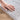 Coastal Mist Soft Ash rug soft polyester texture shown by hand