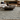 Living room with a patterned rug, coffee table, and couches.