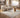Mocha brown area rug styled with neutral living room furniture