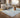 Soft ivory rug styled in a contemporary neutral interior
