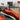 Abstract swirl rug in red, black, and orange styled in modern living room