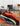 Abstract swirl rug in red, black, and orange styled in modern living room