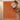 Terracotta rug on a wooden floor with a chair and small table.