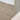 Close-up of a textured beige fabric with a wooden surface in the background