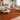 Living room with a Terracota rug, beige sofa, and wooden coffee table.
