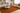 Living room with a Terracota rug, beige sofa, and wooden coffee table.