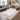 Logan Ivory Border Classic Rug styled in an elegant interior