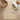 Beige rug on a wooden floor with a chair and plant in the background