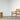 Wooden chair and side table on a textured rug with a plain background